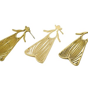 May include: A pair of gold-toned earrings shaped like moths with intricate line designs.