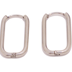 May include: A pair of silver hoop earrings with a rectangular shape.