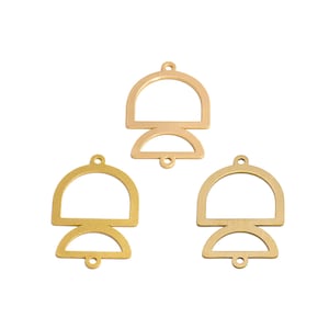 May include: Three gold-colored metal charms with a geometric design. Each charm features a half-circle shape on top and a smaller half-circle shape below, connected by a straight line. The charms have small holes for attaching to jewelry.