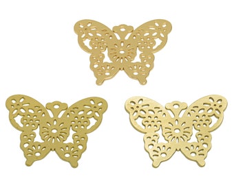 May include: Three gold metal butterfly charms with intricate cut-out designs. The butterflies are about 2 inches wide.