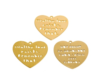 May include: Three gold heart-shaped charms with cut-out lettering. The charms say "Healthy love exists. Remember that." and "UOY MMAMT WM DIVOง กอจ LEEP MHEN I DID".