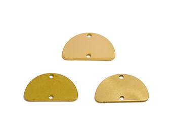 May include: Three gold-colored metal half-circle shapes with two holes each. The shapes are slightly different sizes.