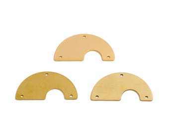 May include: Three half-circle metal shapes with holes in the edges. The shapes are in shades of gold and brass.