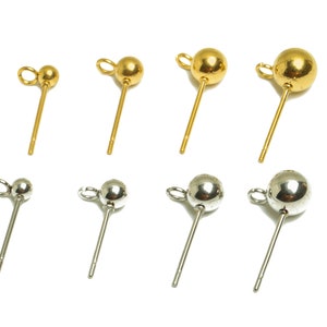 May include: A set of eight earring posts with round ball tops. Four posts are gold-toned and four are silver-toned.