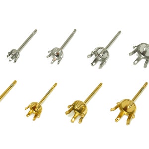 May include: A set of six earring settings, three silver and three gold. Each setting has a pronged crown-like top and a straight post.