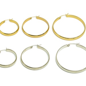May include: Set of four hoop earrings in two sizes and two finishes. Two gold hoop earrings are larger than the two silver hoop earrings.