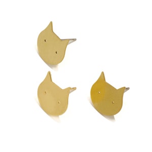 May include: Three gold cat-shaped earring studs. Each stud has a small hole for the earring post.