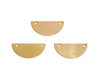 May include: Three gold-colored metal half-circle shapes with two holes at the top. The half-circles are slightly different shades of gold.