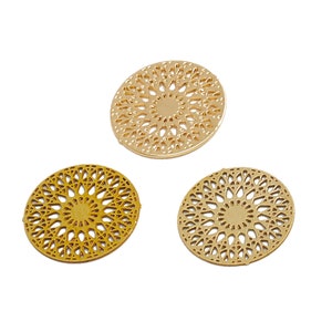 May include: Three gold-colored metal decorative circles with a filigree design. The circles are different sizes and have a shiny finish.