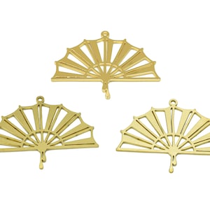 May include: Three gold metal fan-shaped charms with a cutout design.