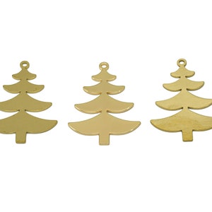 May include: Three gold-coloured metal Christmas tree charms. Each charm is a simple silhouette of a Christmas tree with a loop at the top for hanging.
