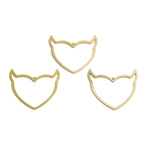 May include: Three gold-colored metal heart-shaped charms with devil horns.