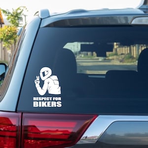May include: A white vinyl sticker with a silhouette of a motorcyclist wearing a helmet and making a peace sign. The sticker says "Respect for Bikers".