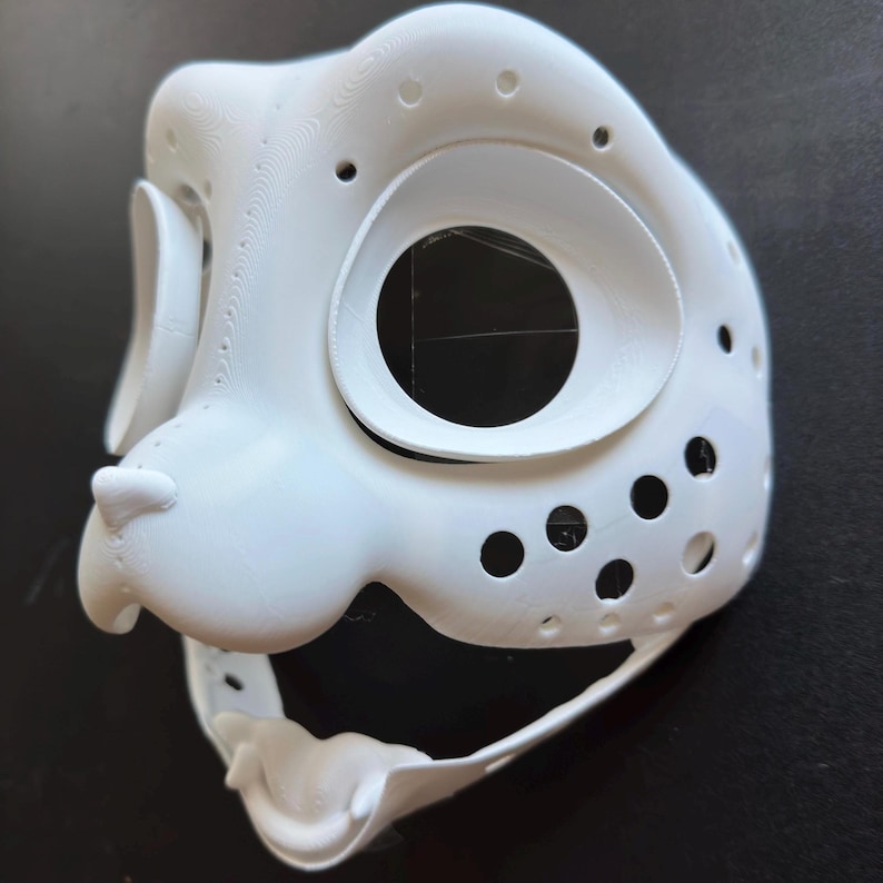 May include: White 3D printed animal mask with holes for eyes and nose. The mask has a textured surface and is designed for fursuit making.