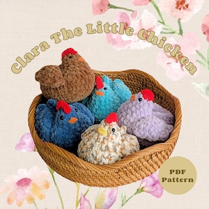May include: A selection of colourful, crocheted chicken toys in a wicker basket. The chickens are in shades of brown, blue, and purple, each with a red comb. The text "Clara The Little Chicken" is above the basket. A "PDF Pattern" label is in the lower right.