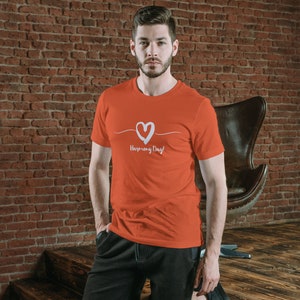 May include: A red t-shirt with a white heart and the text "Happy Every Day!" printed on the front.