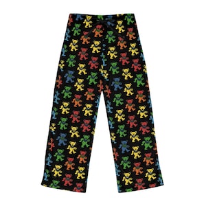 May include: Black pajama pants with a repeating pattern of colorful dancing bears in red, yellow, green, blue, and orange. The pants have a drawstring waist and a relaxed fit, perfect for lounging.