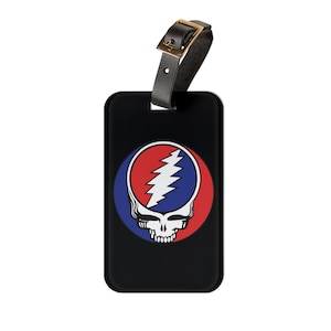 May include: Black leather luggage tag with a red, white, and blue Grateful Dead Steal Your Face logo.