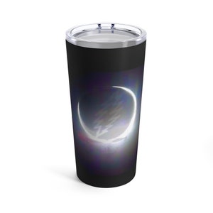 May include: A black stainless steel tumbler with a white crescent moon design on a dark purple and blue background.