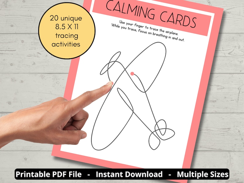 May include: A white paper with a pink border features a black line drawing of an airplane. The text "CALMING CARDS" is at the top. A hand points to the airplane. The paper is 8.5 x 11 inches and has 20 tracing activities.