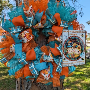 Scarecrow Farms, orange and blue mesh with pumpkin and plain ribbon. A separate bow is available with the wreath.