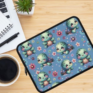 May include: A blue laptop sleeve featuring a repeating pattern of adorable cartoon turtles and flowers. The turtles are green with brown shells and have large eyes. The flowers are pink, purple, and blue.