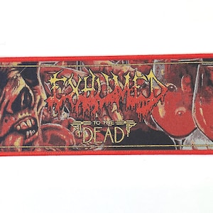 May include: Red, white and gold embroidered patch with the text "Exhumed To The Dead" and a graphic of a skull and two wine glasses.