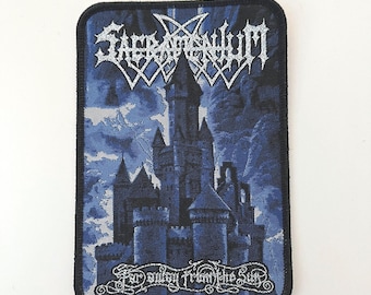 May include: A black and blue embroidered patch with the band name "Satyricon" in silver lettering. The patch features a dark castle against a stormy sky with the text "Far away from the sun" in silver lettering.
