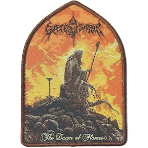 May include: Embroidered patch with a brown border and a design featuring a robed figure holding a staff, set against an orange and yellow sunset. The text "The Dawn of Flames" is at the bottom, with the band's name at the top.