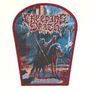 May include: A rectangular patch with a red border features the words "CREEPING DEATH" in a stylized font above an illustration of a cloaked figure on horseback with a scythe. The text "Specter Of War" is below the illustration.