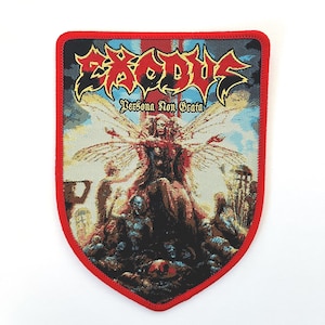 May include: A red, white, and blue woven patch with the band name "Exodus" in large, black letters. The patch features a winged figure with the text "Persona Non Grata" below the figure.