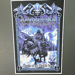 May include: Black and blue poster with a dark figure riding a horse through a snowy landscape. The poster features the band name "Gorgoroth" and the text "Storm of the Light's Bane".