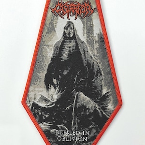 Puede incluir: Un parche negro y gris con un borde rojo. El parche presenta una ilustración detallada de una figura vestida con una apariencia esquelética. El texto "DEFILD IN OBLIVION" está en la parte inferior. La parte superior del parche tiene un texto estilizado en rojo.
