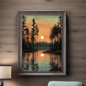 Könnte beinhalten: Ein gerahmtes Landschaftsgemälde zeigt einen Sonnenuntergang über einem See mit silhouettierten Bäumen. Das Kunstwerk hängt über einem türkisfarbenen Sessel mit einem grauen Kissen. Ein kleiner Beistelltisch mit einer Lampe und einer Tasse steht in der Nähe und schafft eine gemütliche Innenszene.