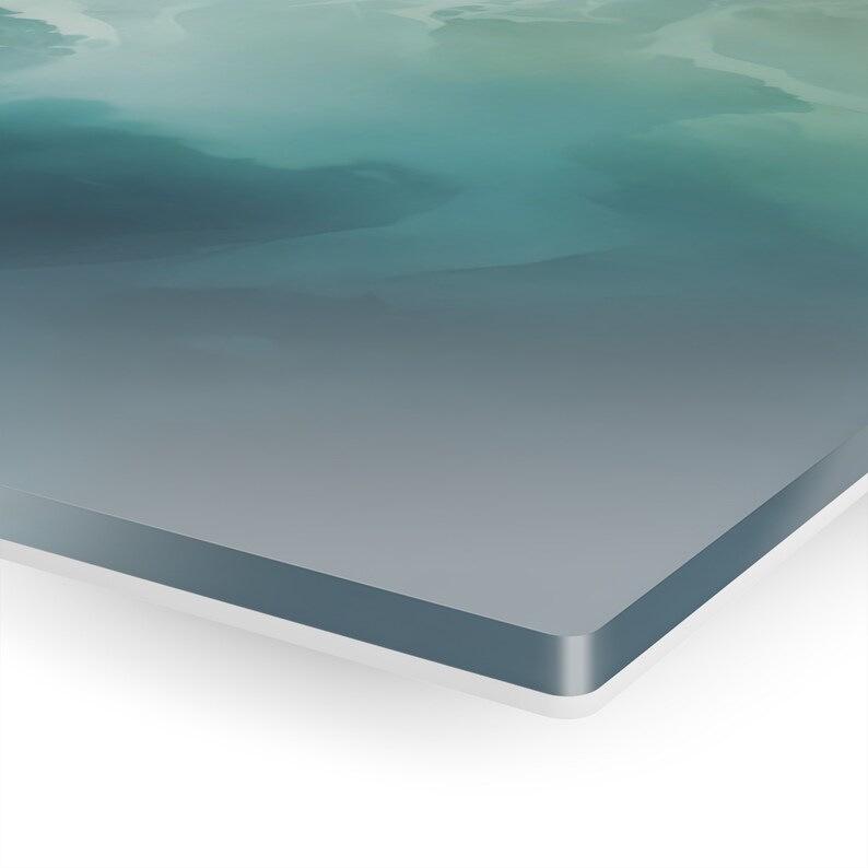 May include: A close-up of a teal and gray abstract painting on a canvas with a white frame.