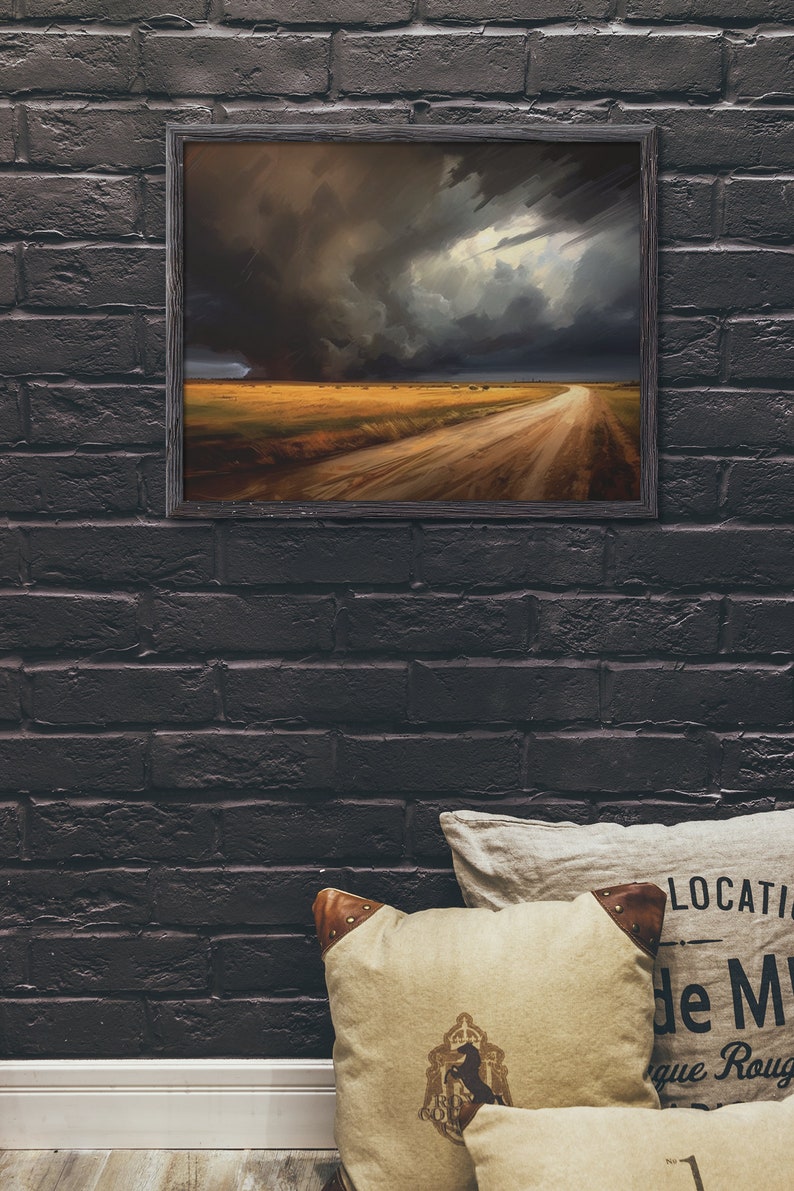 May include: A framed painting of a dirt road leading into a field with a dramatic stormy sky in the background.