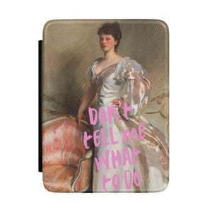 May include: A tablet case featuring a vintage painting of a woman in a white dress with the text "DON'T TELL ME WHAT TO DO" in pink. The case has a black border and a portrait-style orientation.