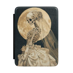 May include: A rectangular e-reader case featuring a dark textured background with a graphic illustration of a skeleton wearing a white wedding dress and veil, holding a bouquet of flowers against a large, pale yellow full moon in the background.