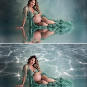 May include: A pregnant person wearing a flowing, sage green maternity gown. The gown features delicate lace detailing on the sleeves and bodice. The person is seated on a reflective surface, with a soft, blue-green background.