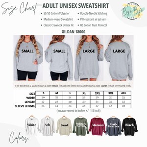 May include: Adult unisex sweatshirt size chart with measurements in inches. Features a size chart with width, length, and sleeve length for sizes S to 4XL. Includes color options: white, ash, sand, military green, maroon, dark heather, and black.