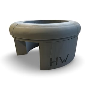 May include: A grey 3D printed cup holder with the letters "HW" printed on the side.