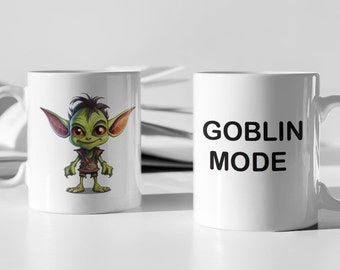 May include: Two white ceramic mugs. One mug features a green goblin cartoon character. The other mug has the text "GOBLIN MODE" in black.