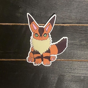 May include: A sticker of a cartoon fox with orange and brown fur, a white chest, and green eyes. The fox is sitting on its hind legs with its tail curled behind it.