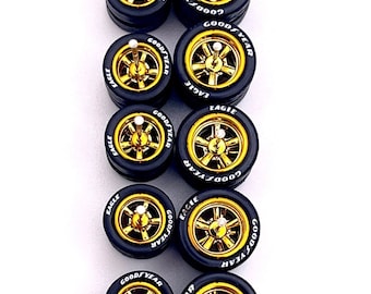 May include: Gold electroplated Cragar wheels with black tires. The wheels have a gold center and the Goodyear and Eagle tire brands are visible. The text "Staggered 11mm / 13nm" is also present.