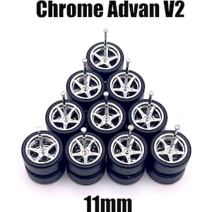 May include: A set of ten 11mm chrome Advan V2 wheels for 1/64 scale diecast cars. The wheels are silver with black tires and are arranged in a triangle shape.