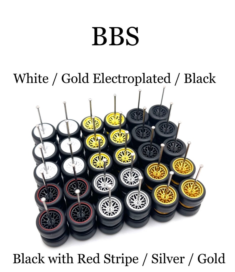 May include: A collection of 36 miniature BBS wheels for model cars. The wheels are in four different styles: white with gold electroplated rims, black with red stripe, silver, and gold. The wheels are arranged in a grid pattern and are all mounted on small metal axles.