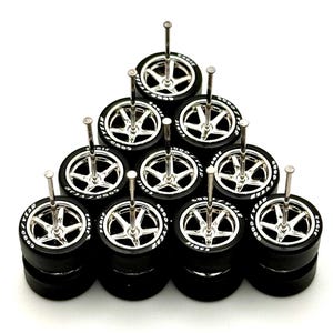 May include: A set of ten silver-colored miniature car wheels with black tires and white "GOODYEAR EAGLE" lettering. The wheels are mounted on small metal rods.