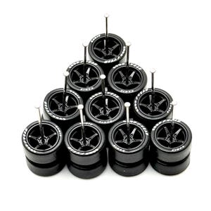 May include: A set of ten black miniature car wheels with white lettering on the tires. The wheels are arranged in a triangle shape and are displayed on a white background.