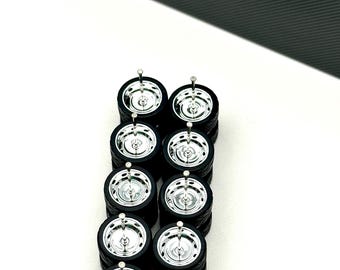 May include: Ten miniature model car wheels arranged in two vertical columns. Each wheel features a black rubber tire and a shiny chrome-finished rim with a central hub. The text SHOP164 is printed in white on a black background in the upper corner.