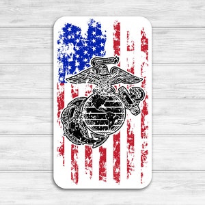 May include: A distressed American flag with a black and white Marine Corps emblem in the center. The emblem features a globe, an eagle, and an anchor.